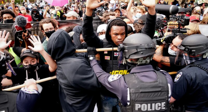 FILE - Police and protesters converge during a demonstration, Wednesday, Sept. 23, 2020, in Louisville, Ky. Recent revelations about the search warrant that led to Breonna Taylor