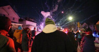 People react after a firework was set off near the scene of a reported shooting Wednesday, Jan. 14, 2026, in Minneapolis. (AP Photo/Abbie Parr)