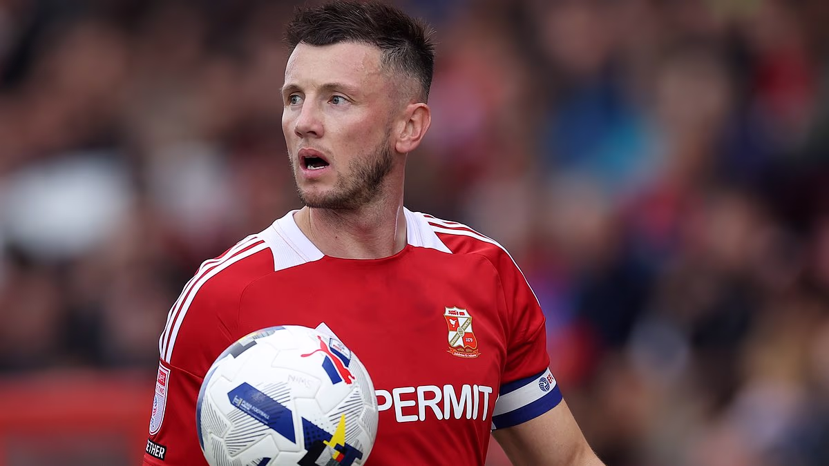 Footballer banned for 'violating rival's private parts', leaving him unable to speak, PLAYS in match despite seven-game suspension - as rules loophole sparks bizarre row