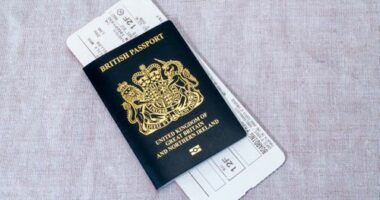 London, United Kingdom - March 7th, 2023 :   A new blue British passport with an airline boarding pass.  Since the United Kingdom has left the European Union in 2020, new British passports have returned to their original blue colour.