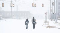 Jimmy Jordan, left, and Cordarol Dale walk through snow in Memphis, Tenn., Saturday, Jan. 24, 2026. (Mark Weber/Daily Memphian via AP)