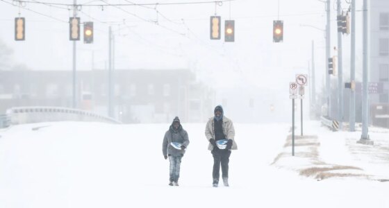 Jimmy Jordan, left, and Cordarol Dale walk through snow in Memphis, Tenn., Saturday, Jan. 24, 2026. (Mark Weber/Daily Memphian via AP)