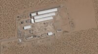 FILE - This Aug. 7, 2025, satellite image shows construction of large white tents for a new immigrant detention center at Fort Bliss, a U.S. Army base outside El Paso, Texas. (Planet Labs via AP, File)