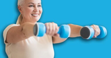 Joyful woman working out with hand weights