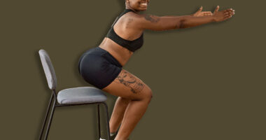 Young african american couple training using chair at sport center.