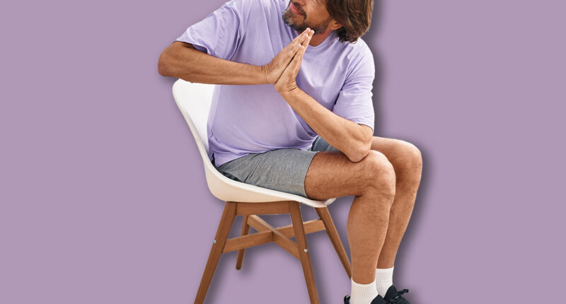 Middle age man smiling confident sitting on chair stretching at sport center