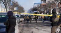 Federal agents stand near the site of a shooting Saturday, Jan. 24, 2026, in Minneapolis. (AP Photo/Abbie Parr)