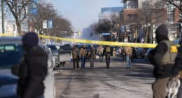Federal agents stand near the site of a shooting Saturday, Jan. 24, 2026, in Minneapolis. (AP Photo/Abbie Parr)