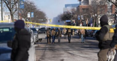 Federal agents stand near the site of a shooting Saturday, Jan. 24, 2026, in Minneapolis. (AP Photo/Abbie Parr)