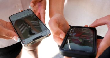 FILE - Young people use their phones to view social media in Sydney, Nov. 8, 2024. (AP Photo/Rick Rycroft, File)