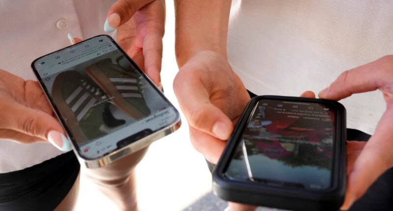 FILE - Young people use their phones to view social media in Sydney, Nov. 8, 2024. (AP Photo/Rick Rycroft, File)