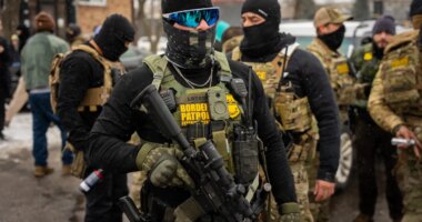 Federal agents stand guard, Wednesday, Jan. 21, 2026, in Minneapolis. (AP Photo/Angelina Katsanis)