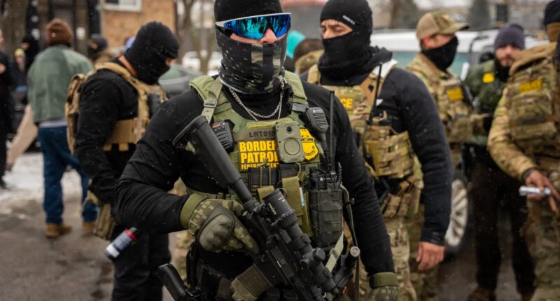 Federal agents stand guard, Wednesday, Jan. 21, 2026, in Minneapolis. (AP Photo/Angelina Katsanis)