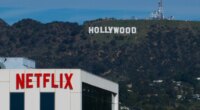 FILE - A Netflix sign is displayed atop a building in Los Angeles, on Dec. 18, 2025, with the Hollywood sign in the distance. (AP Photo/Jae C. Hong, File)