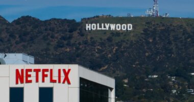 FILE - A Netflix sign is displayed atop a building in Los Angeles, on Dec. 18, 2025, with the Hollywood sign in the distance. (AP Photo/Jae C. Hong, File)