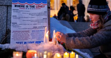 Candles burn around a poem written by Renee Good during a vigil honoring her on Friday, Jan. 9, 2026, in St. Paul, Minn., outside the Minnesota State Capitol. (Kerem Yücel/Minnesota Public Radio via AP)