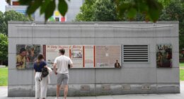 FILE - People look an informational panel at President