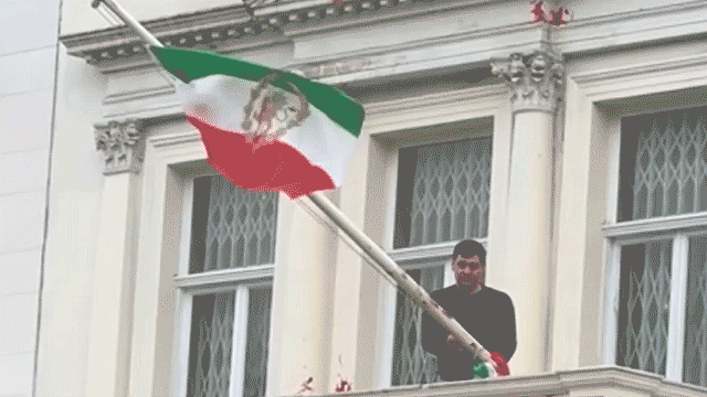Protester scales Iranian Embassy in London, tears down regime flag, hoists pre-revolution symbol