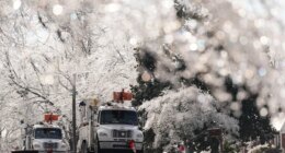 Utility trucks are seen through ice covered trees Wednesday, Jan. 28, 2026, in Nashville, Tenn. after a winter storm passed through area over the weekend. (AP Photo/George Walker IV)