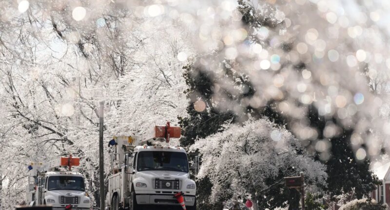 Utility trucks are seen through ice covered trees Wednesday, Jan. 28, 2026, in Nashville, Tenn. after a winter storm passed through area over the weekend. (AP Photo/George Walker IV)