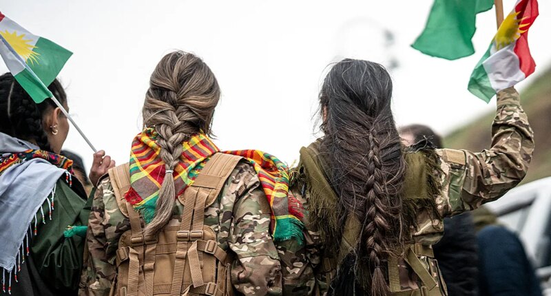 Syrian militiaman shows off what he claims to be severed Kurdish fighter's braid as Damascus asserts control