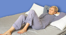 beautiful elderly woman in pajamas lies on the bed