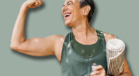 Happy elderly woman celebrating her fitness achievement after a great outdoor workout session, flaunting her strong bicep. Fit senior woman expressing her pride in her successful exercise routine.