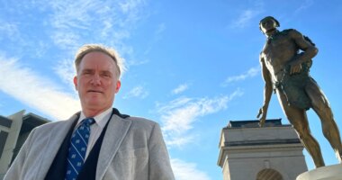 FILE - Developer Rodney Mims Cook Jr. stands next to the statue of Chief Tomochichi he commissioned for Atlanta