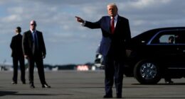 President Donald Trump points after arriving at Palm Beach International Airport on Air Force One, Friday, Jan. 16, 2026, in West Palm Beach, Fla. (AP Photo/Julia Demaree Nikhinson)
