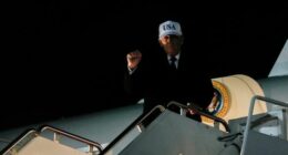 US President Donald Trump gestures while disembarking Air Force One after returning from Florida, Sunday, Jan. 11, 2026.