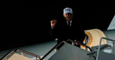 US President Donald Trump gestures while disembarking Air Force One after returning from Florida, Sunday, Jan. 11, 2026.