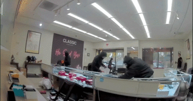 Video shows masked robbers crash car through jewelry store entrance, steal owner's gun in brazen heist