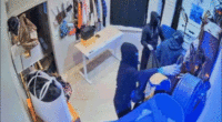 Video shows terrifying moment masked California burglars blitz high-end store, escape in luxury SUVs