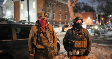 EDS NOTE: OBSCENITY - Armed community response members patrol near the scene where 37-year-old Alex Pretti was fatally shot by a U.S. Border Patrol officer earlier in the day, Saturday, Jan. 24, 2026, in Minneapolis. (AP Photo/Adam Gray)