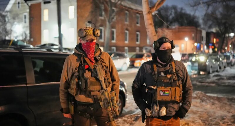 EDS NOTE: OBSCENITY - Armed community response members patrol near the scene where 37-year-old Alex Pretti was fatally shot by a U.S. Border Patrol officer earlier in the day, Saturday, Jan. 24, 2026, in Minneapolis. (AP Photo/Adam Gray)