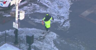 WATCH: Crossing guard carries child across flooded Chicago street