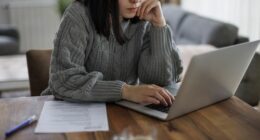 Determined woman reviewing job opportunities online