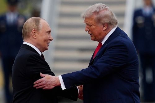 US President Donald Trump greets Russian President Vladimir Putin