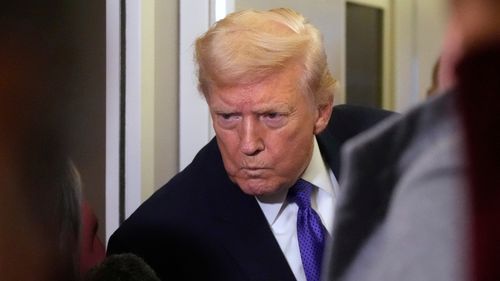 President Donald Trump listens to a reporter's question as he flies aboard Air Force One from Joint Base Andrews, Md., to West Palm Beach, Fla., Friday, Feb. 6, 2026