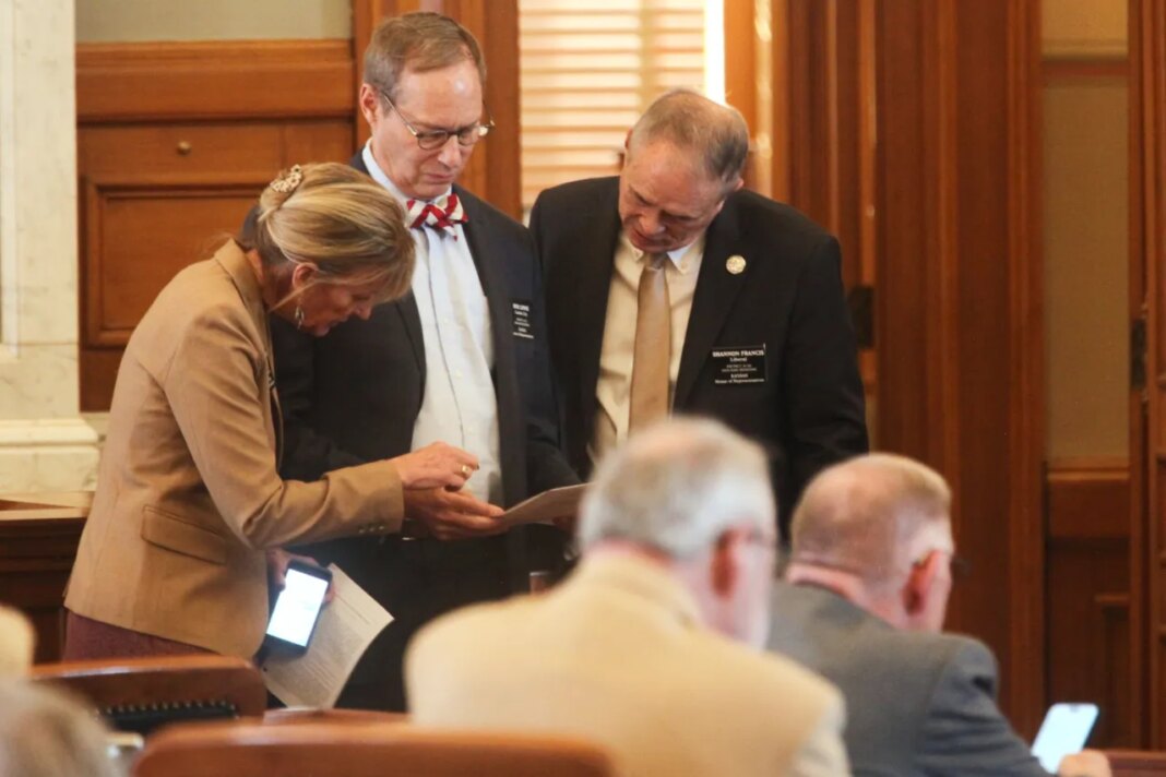 Kansas State Reps. Susan Humphries, left, R-Wichita; Bob Lewis, center, R-Garden City, and Shannon Francis, right, R-Liberal, confer during a House debate on a measure to prevent transgender people from changing their driver