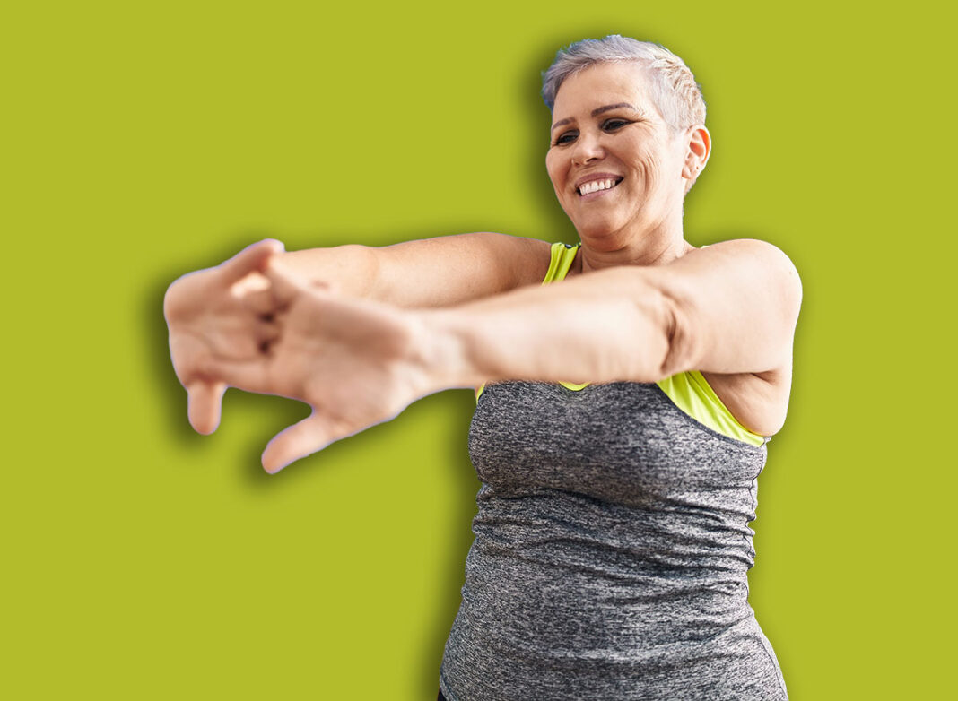 Middle age woman smiling confident stretching at sport center