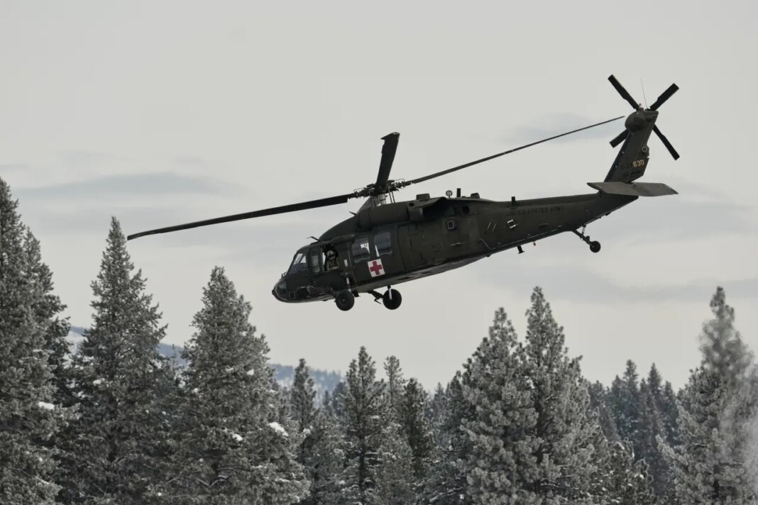 A U.S. Army Blackhawk helicopter takes off from the Truckee Tahoe Airport as recovery efforts for a group of missing skiers continue, continue in Truckee, Calif., Saturday, Feb. 21, 2026. (AP Photo/Godofredo A. Vásquez)
