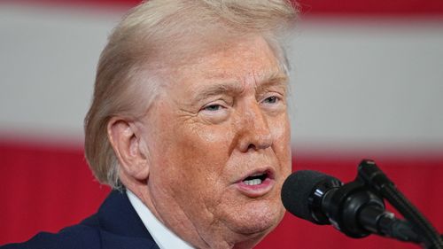 President Donald Trump on Thursday pardoned five former professional football players, including one posthumously.