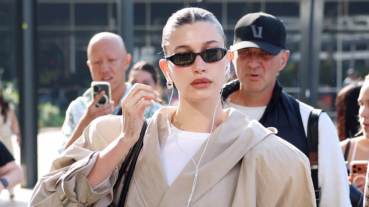 Hailey Bieber cuts a chic figure as she arrives in Sydney with a huge entourage ahead of Australian launch of her skincare brand Rhode