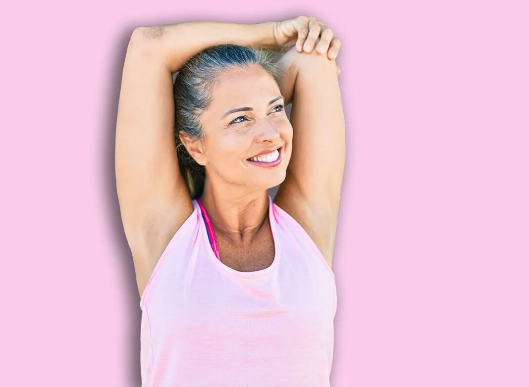 Middle age sportswoman smiling happy training at the park