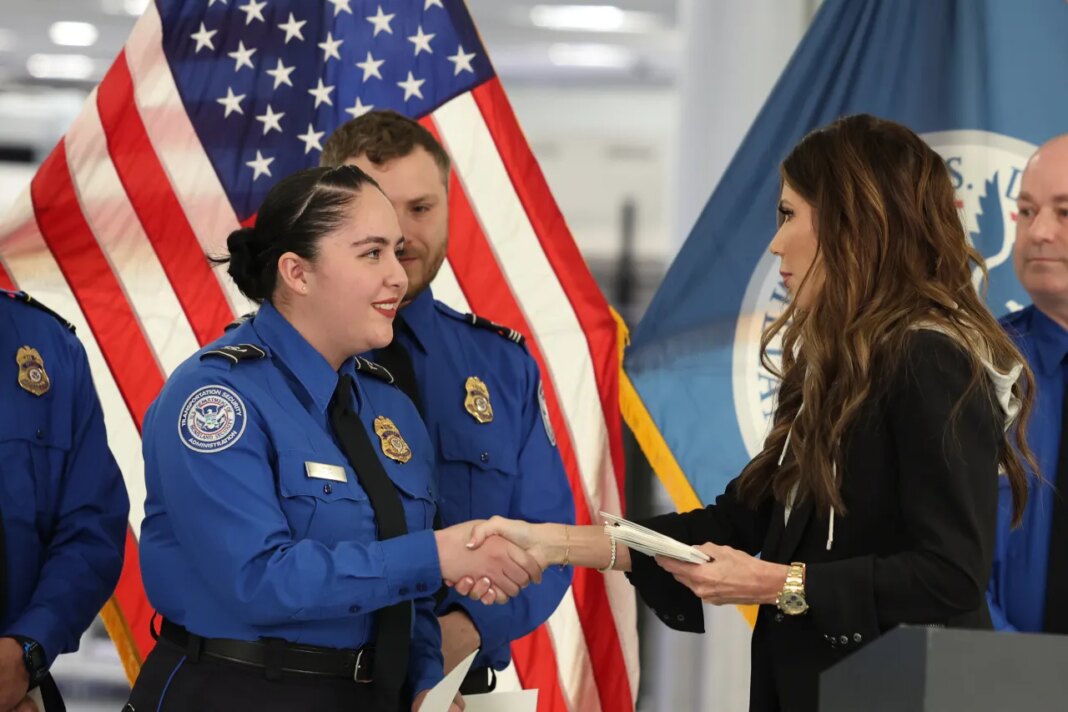 FILE - U.S. Homeland Security Secretary Kristi Noem, right, shakes hands with Transportation Security Administration Officer Monica Degro at a news conference at Harry Reid International Airport, Nov. 22, 2025, in Las Vegas. (AP Photo/Ronda Churchill, File)