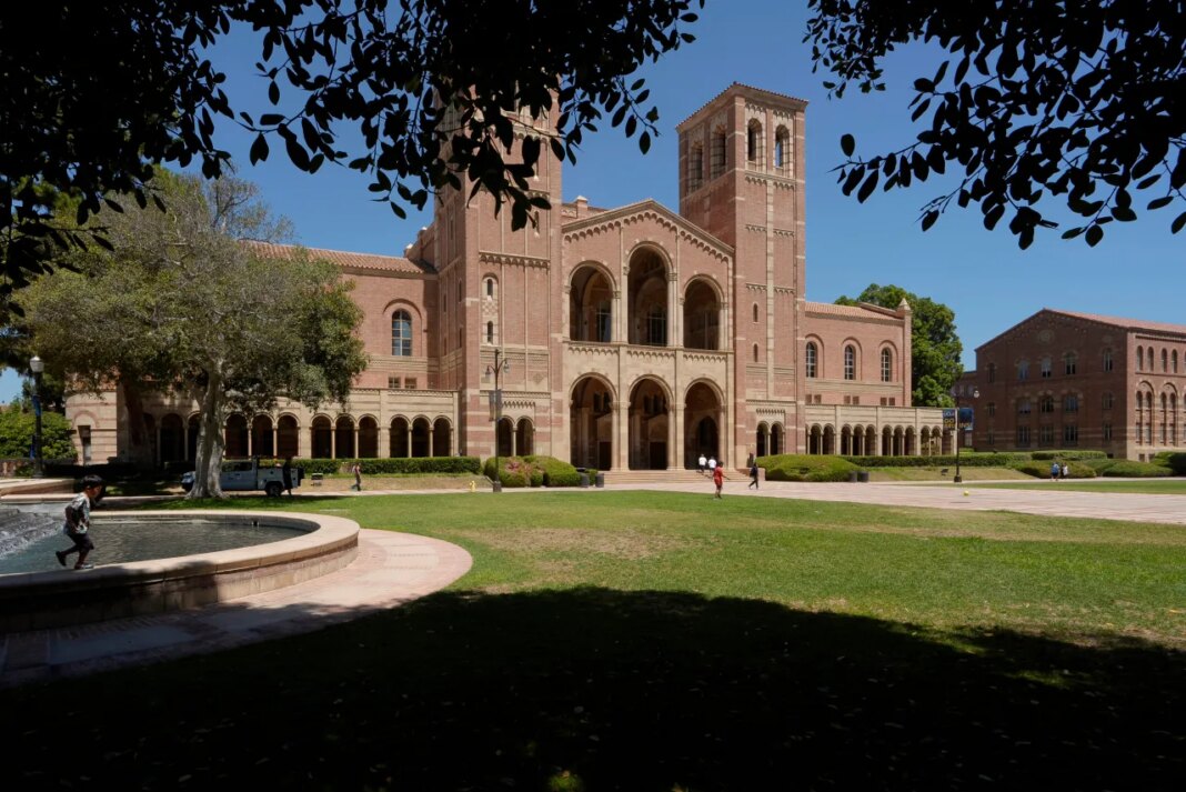 FILE - Children play outside Royce Hall at the University of California, Los Angeles, campus, Aug. 15, 2024. (AP Photo/Damian Dovarganes, File)