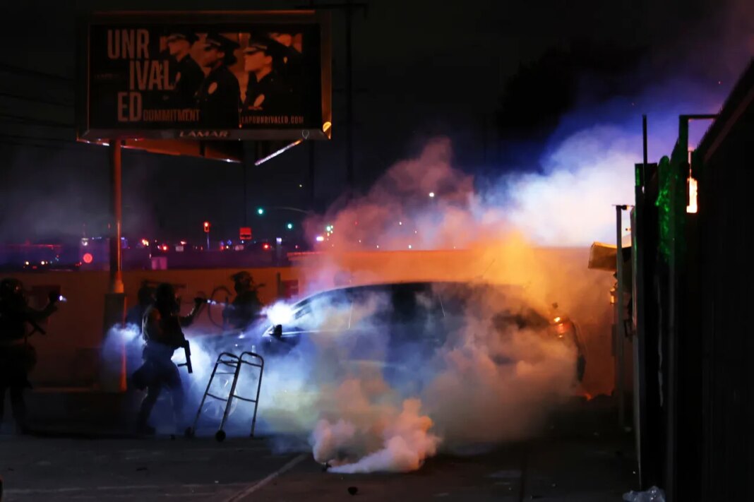 FILE - Law enforcement investigate a car with a person inside during a protest in Compton, Calif., June 7, 2025, after federal immigration authorities conducted operations. (AP Photo/Ethan Swope, file)
