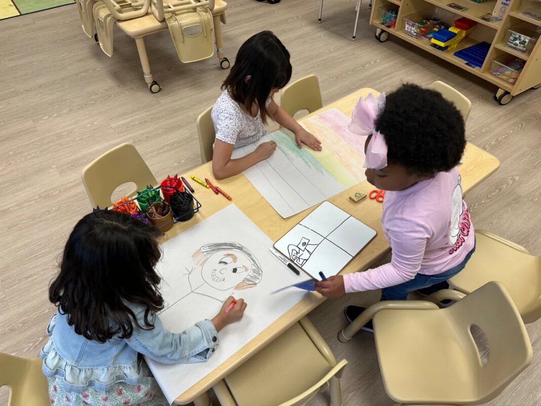 CHhildren drawing after school inside one of the classrooms at the Children