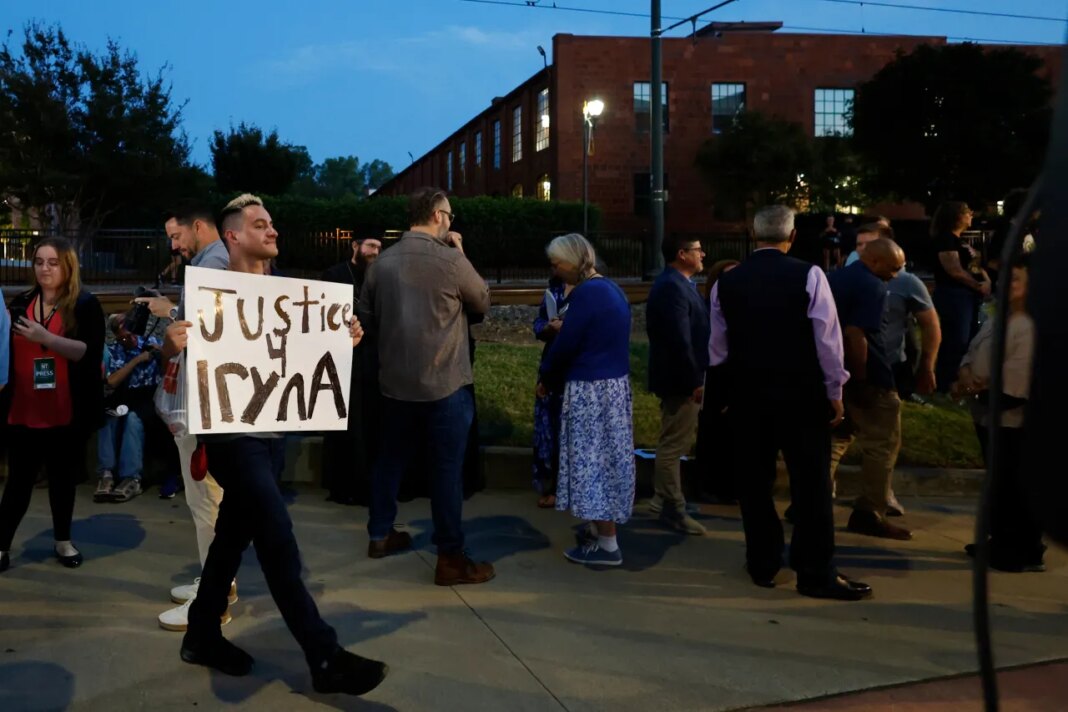 FILE - Michael Bermudez of Spartanburg, S.C., holds a sign at a vigil honoring the life of Iryna Zarutska, who was fatally stabbed on a commuter train last month, Monday, Sept. 22, 2025, in Charlotte, N.C. (AP Photo/Nell Redmond, File)